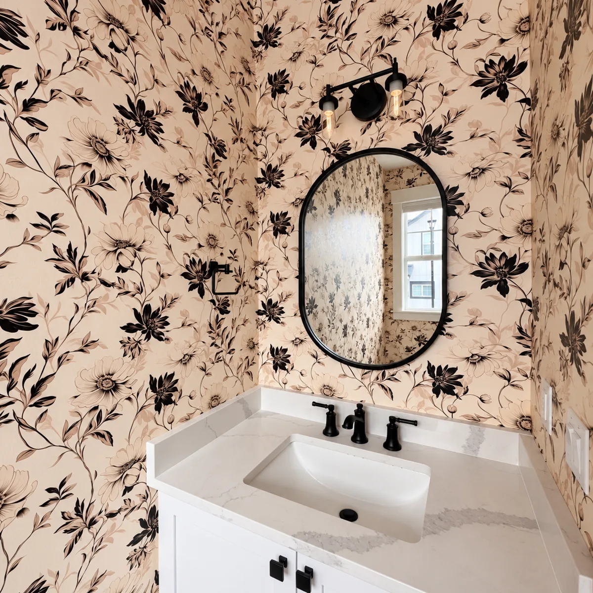 Same powder room after installation of black-and-cream floral wallpaper