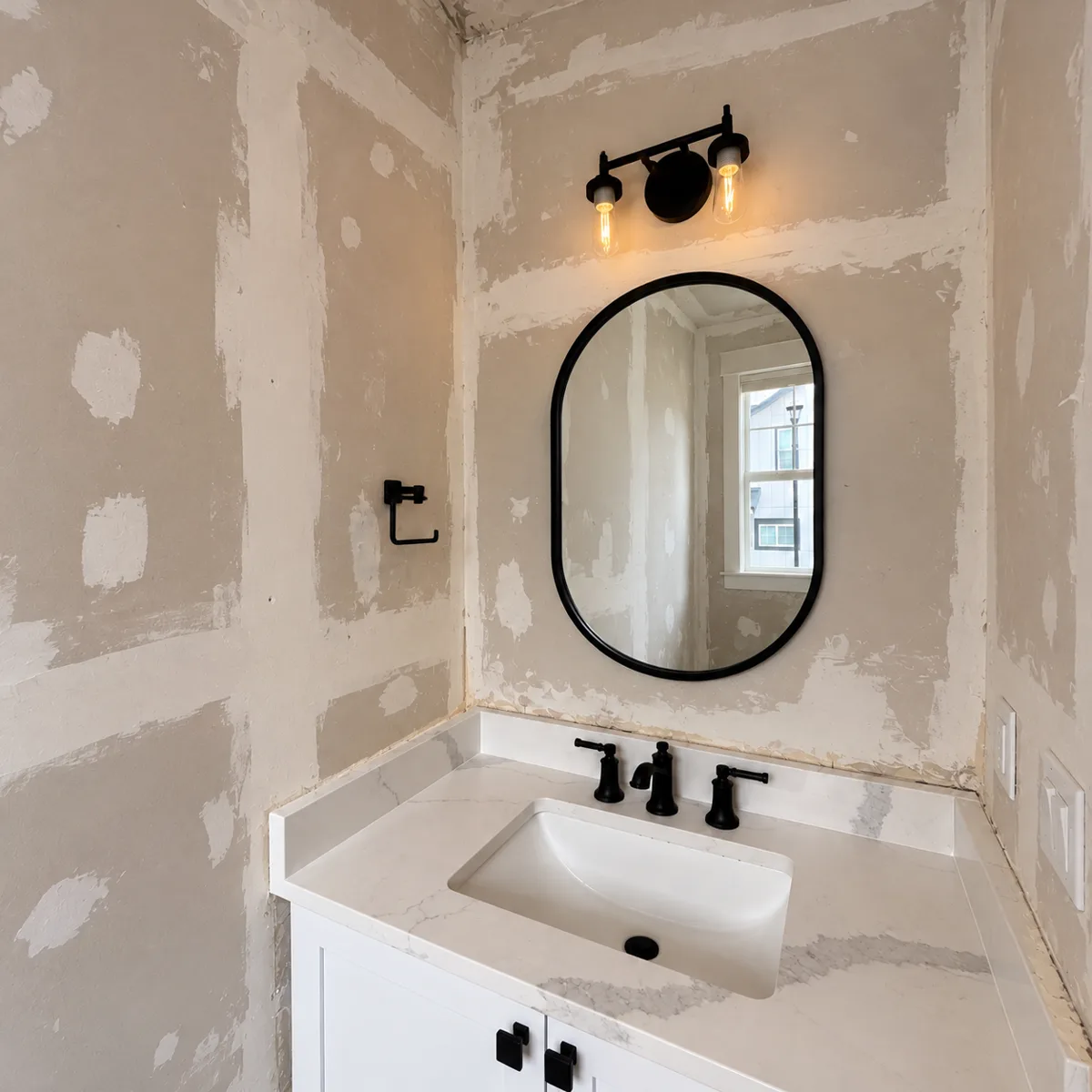 Powder room before: patched, unfinished drywall