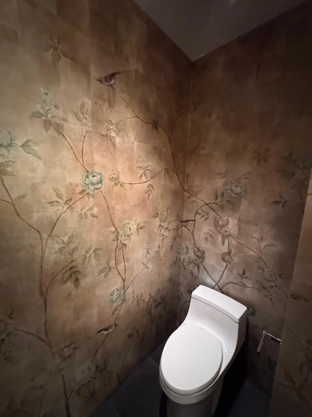 Chinoiserie bird and peony mural continuing across an inside corner