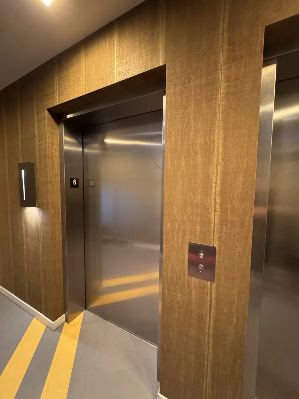 Seamless commercial vinyl wallcovering wrapped around elevator returns