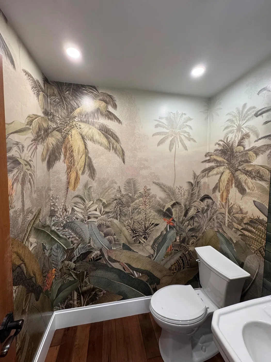 Tropical palm mural wallpaper installed in a powder room